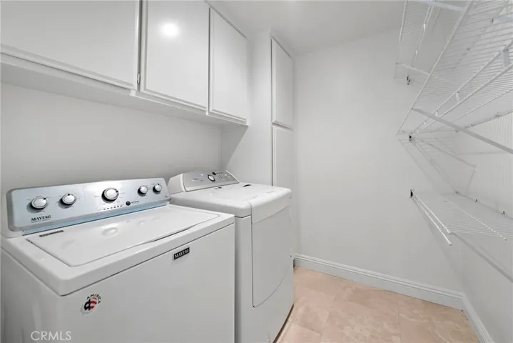 Laundry room with plenty of storage and extra shelving