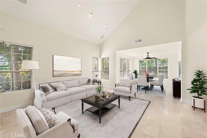 As you step into this elegent living room; notice the soaring celings and abundance of natural light (virtual staging)