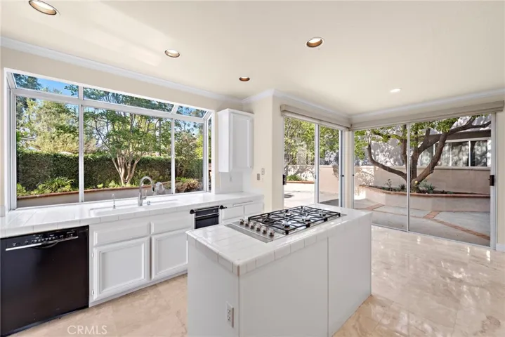 The kitchen and dining area are enhanced by an abundance of oversized windows allowing for natural light to stream in