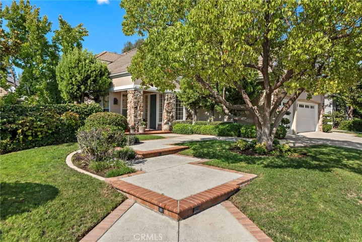 This home has such an inviting entrance from the gorgeous tree to brick lined steps
