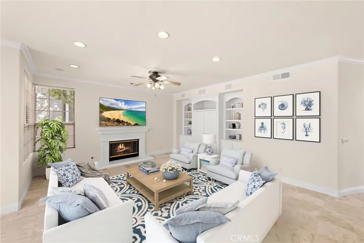  With a fireplace and custom built-ins, this family room is a great place for family gatherings or just to hang out (virtual staging)