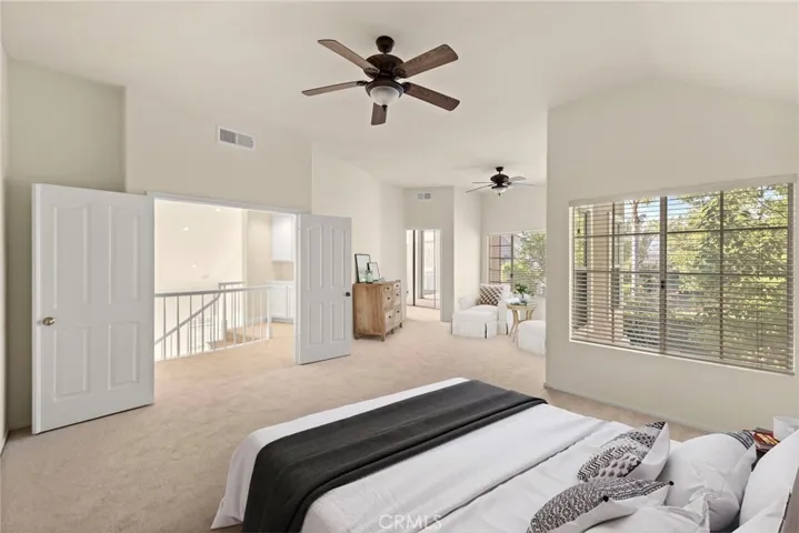 Double entry into Main en suite bedroom showcaes all the nautral light in the room (virtual staging)