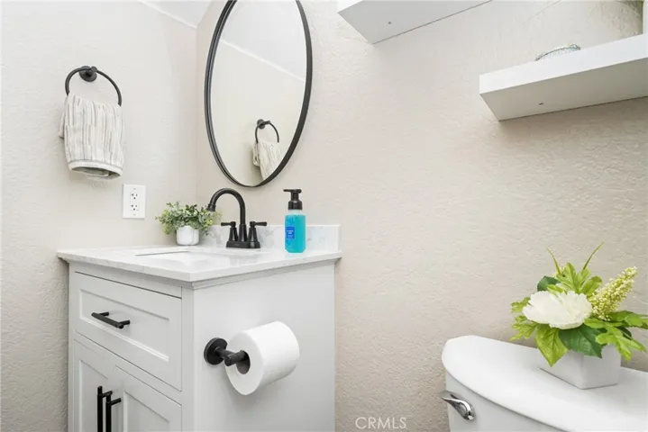 The contemporary flair from the main living area is carried into the guest powderroom!