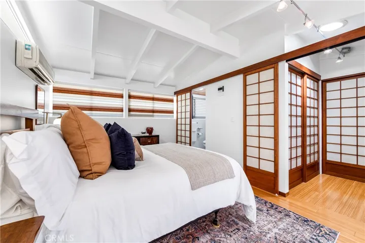 Primary room looking towards the en suite and gorgeous Shoji closets