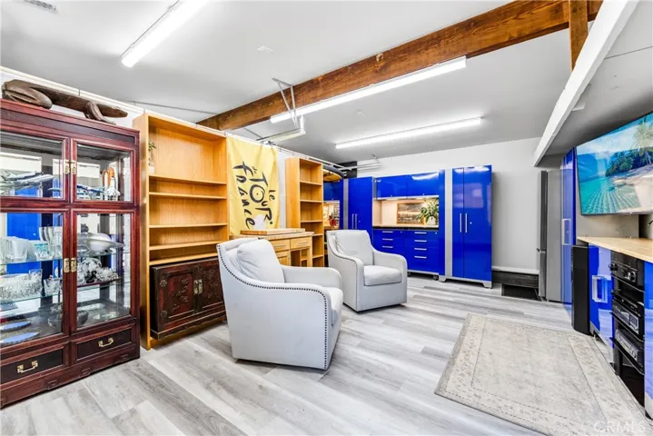 Fully garage with beautiful cabinetry and finished floors