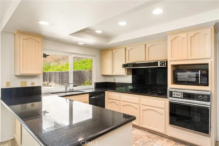 Granite Counters in the Kitchen with Wood Cabinetry