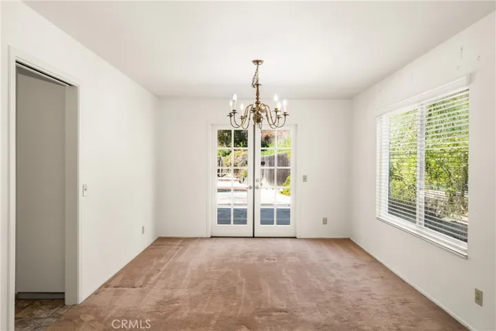 Formal Dining Room with French Doors to the Covered Patio and Pool Area