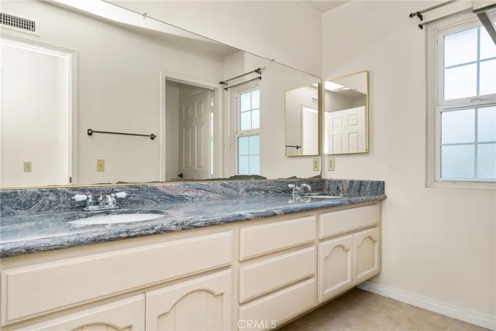 Secondary Bathroom with Dual Vanities and Granite Counters