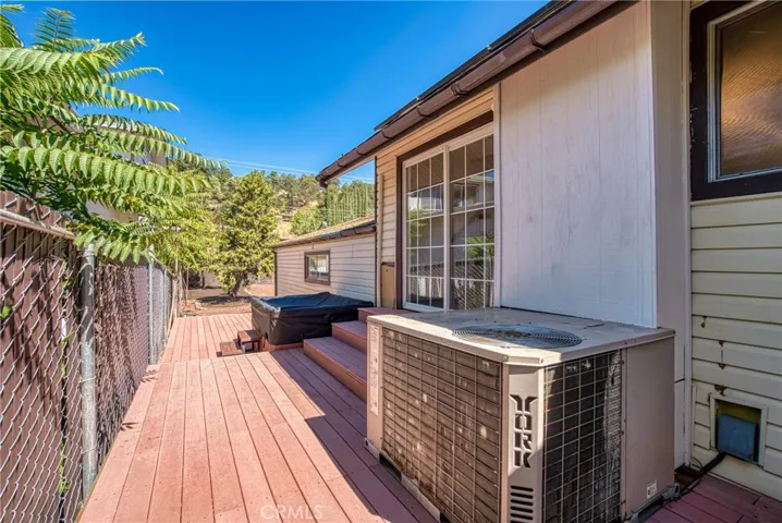 Side yard and deck with hot tub.