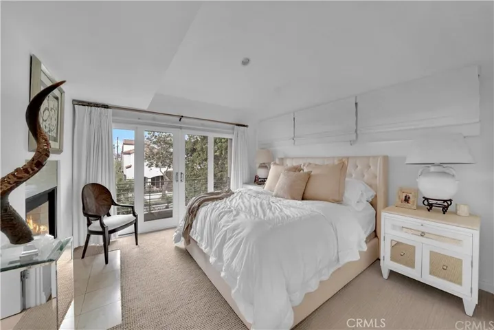Primary bedroom with fireplace & balcony