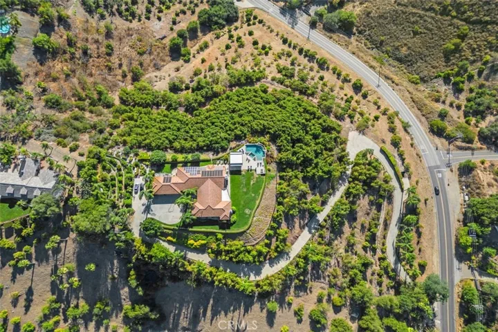 Large flat acre pad on the top of the lot with groves above and below.