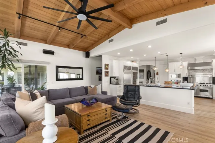 Vaulted wood planked ceilings, built-in cabinets, and cozy fireplace in family room.