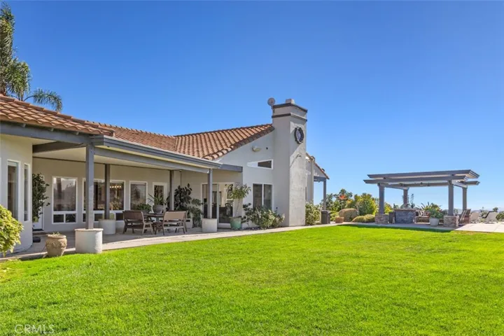 View of the back of the house and backyard pergola.