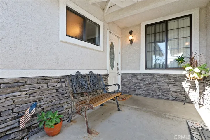 Front door to left and garage side door to the right