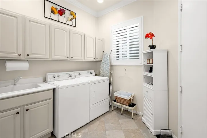 Laundry Room with Sink and Storage Cabinets. Large Pantry is in Laundry Rm which is off the Kitchen.