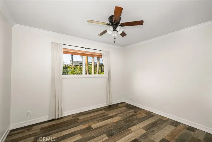 Spacious bedroom 3 with ceiling fan and large window