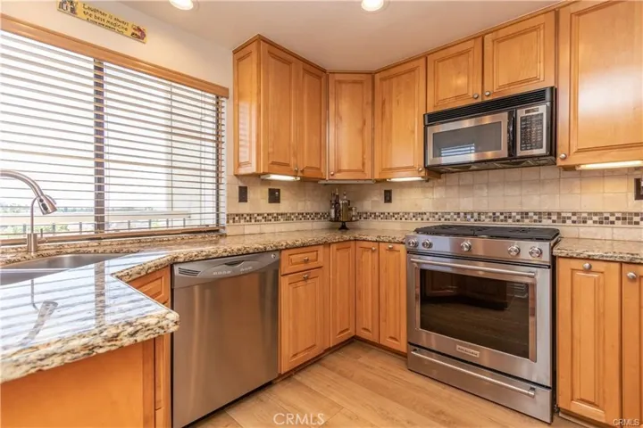 Remodeled kitchen with granite counters and maple cabinets
