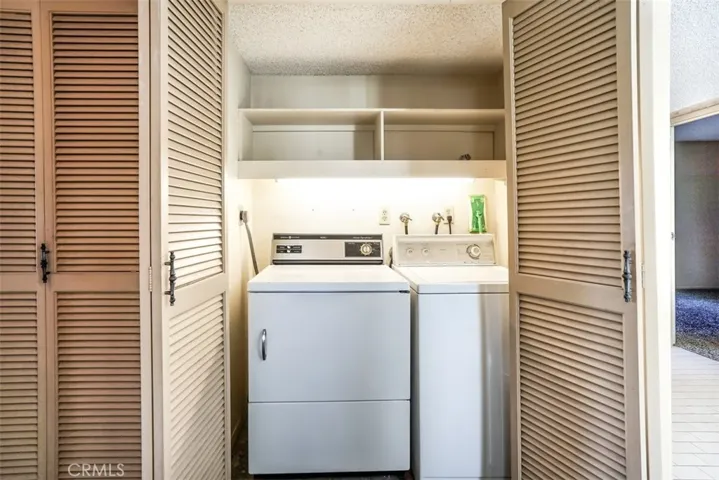The laundry area is tucked away behind doors for easy access.
