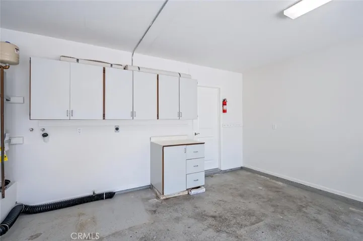 Garage has washer dryer hook up and cabinets. enters into kitchen