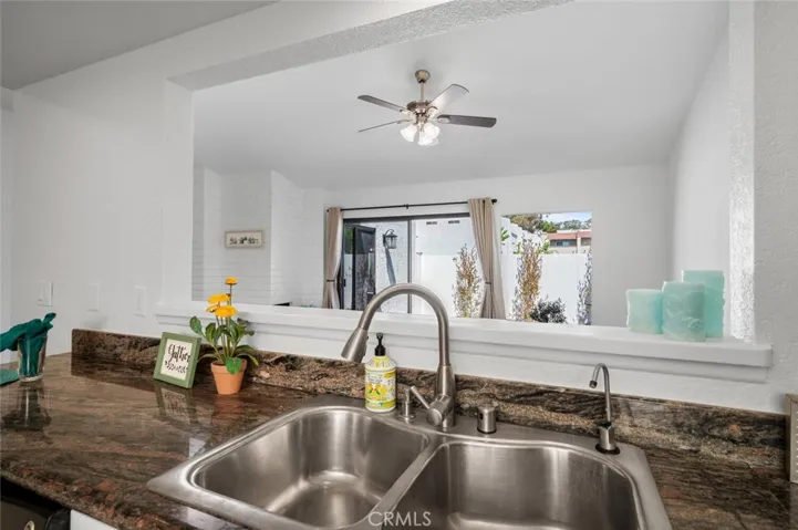 Kitchen is open to the living room and beyond to patio