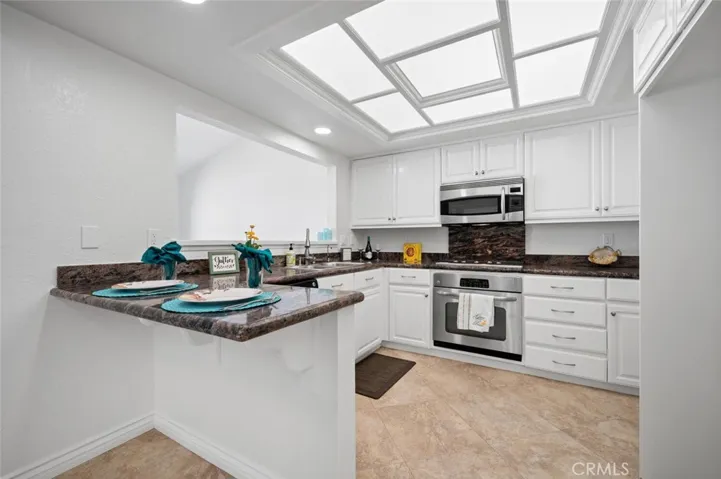 Kitchen has huge skylight and breakfast bar