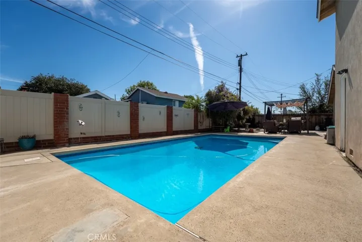  The sparkling pool beckons for warm-weather fun, while the well-maintained yard offers ample space for entertaining or relaxing.