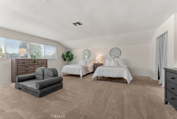 This light-filled area features plush carpeting and large windows that provide natural light.