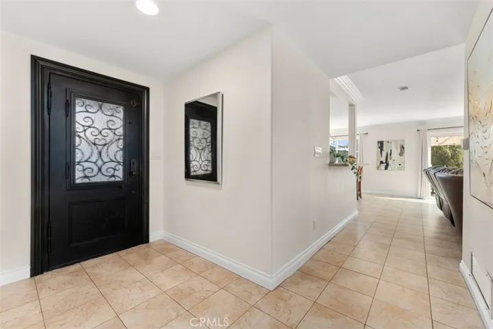 Welcoming entry way featuring an elegant iron door.