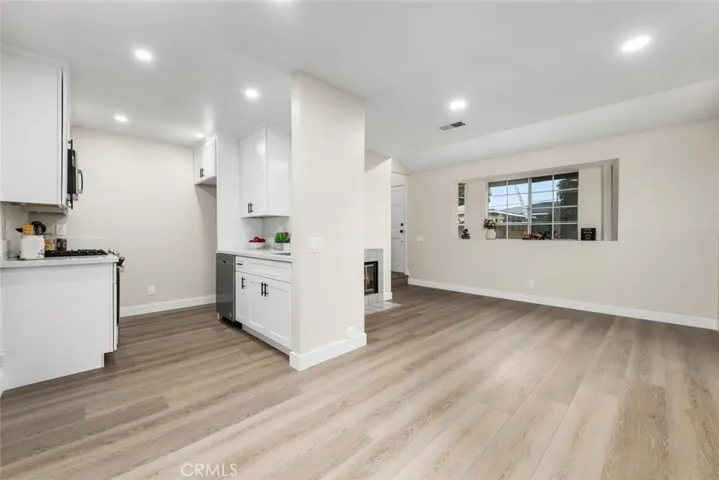 Living room to dining area to kitchen flow.