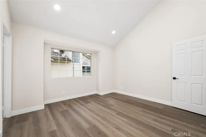 Primary bedroom with vaulted ceilings.