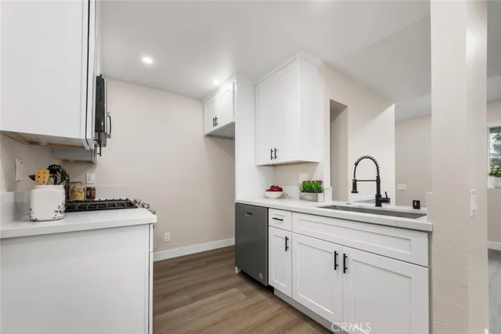 Kitchen renovations with shaker style cabinetry and quartz countertops.