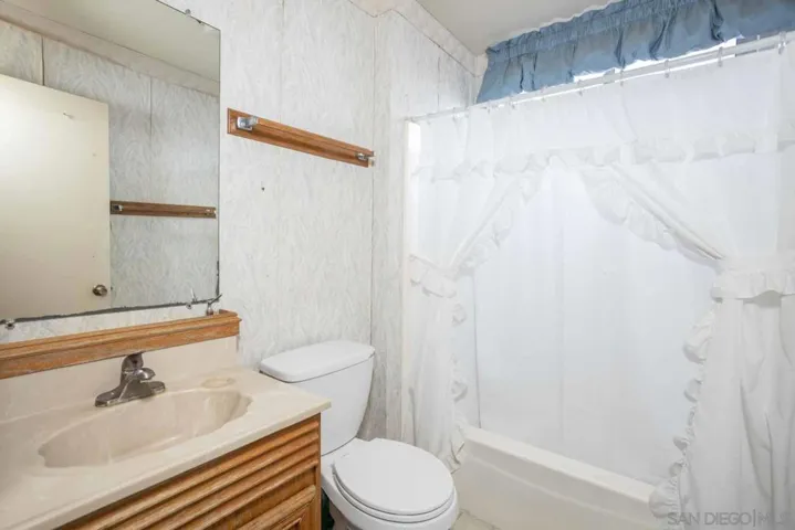 Guest bath with tub and shower combo.