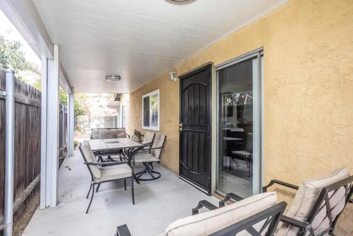 One of two covered patios. "Alumawood" type, professionally installed cover with vinyl fencing and wood fencing.