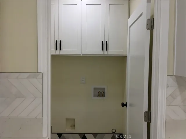 Cabinets above washer and dryer spaces.