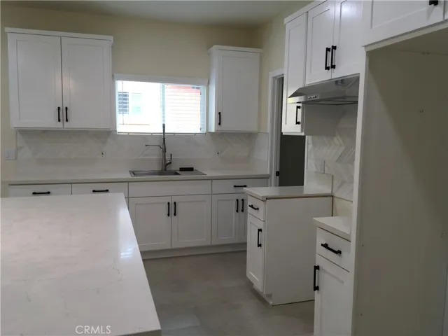 View of the kitchen headed to the hall