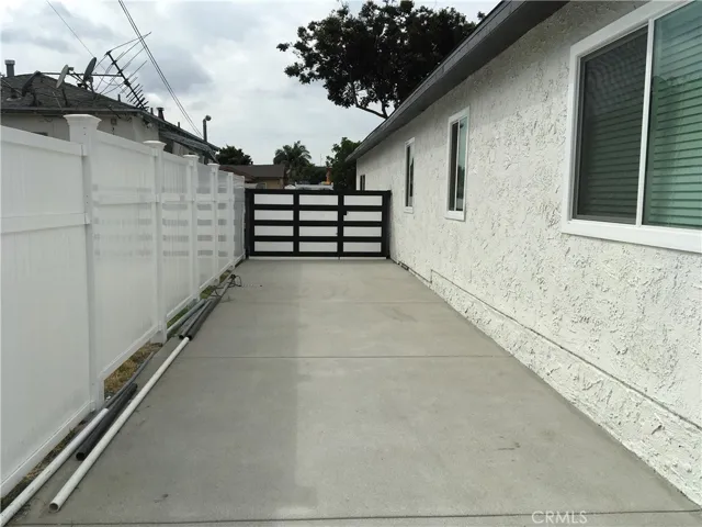 Gated driveway, serving as a patio for the front house