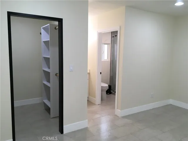 View of master bedroom walk-in closet, bathroom