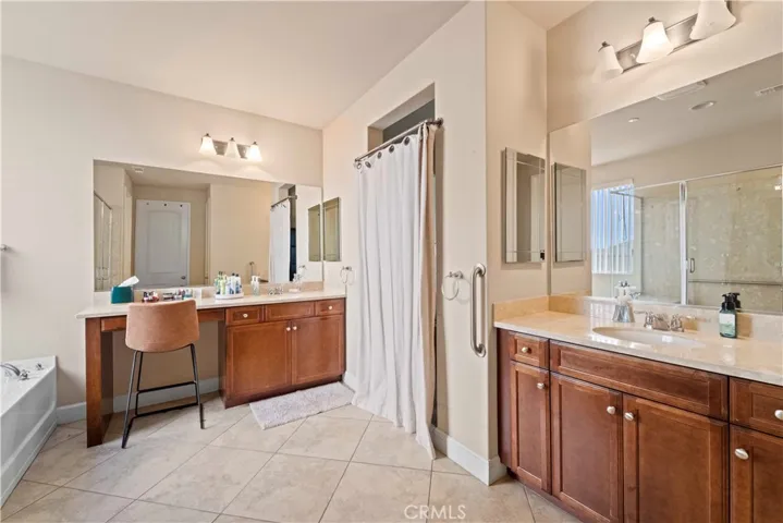 Primary bathroom with dual sinks, oversized bathtub and walk in shower. Generous closet attached.