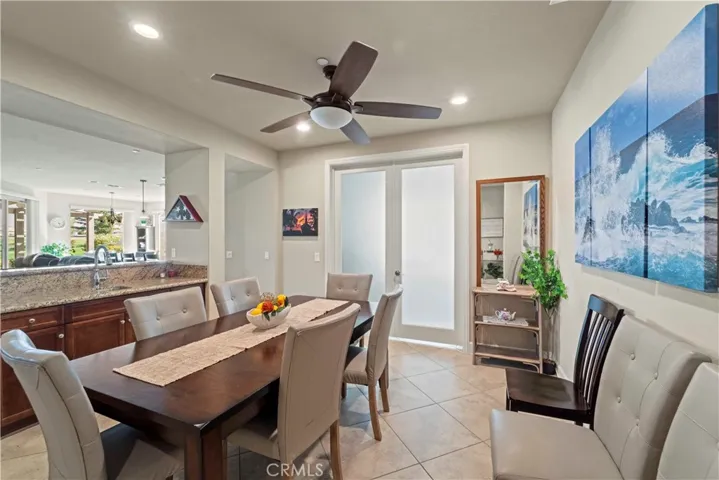 Dining area with sink bar and French doors leading into the office