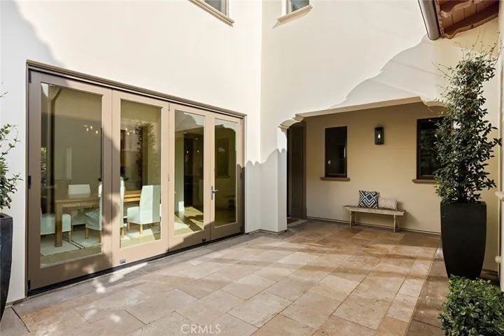 Main residence entry to left, casita entry to right. Covered by roof between.