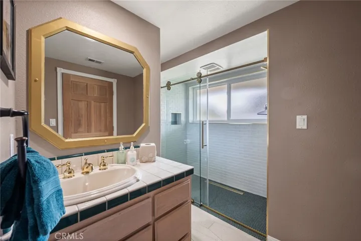 There are separate sinks, a remodeled walk in shower, and the water closet is around the corner.