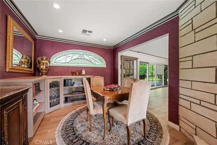 Game room, or this could be a library, with a beautiful stain glass window above the built-in book cases.