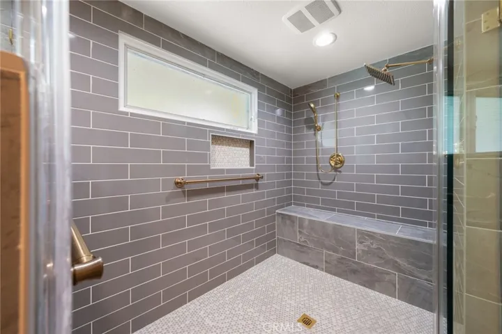 Newer dual shower heads and a hand held shower head too. Beautiful thick frameless glass enclosure and gold accent trim.