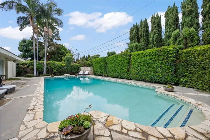 The private pool area is separate from the grassy yard with a wrought iron fence for security. This is a quiet private retreat for a great place to relax.