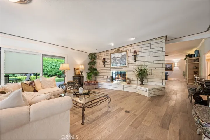 Very large living room with stone faced fireplace.