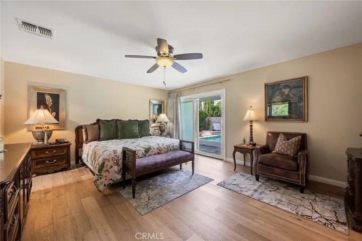 The primary bedroom is located right off the pool outside, 2 walk-in closets, wood floors and a huge primary bathroom attached.