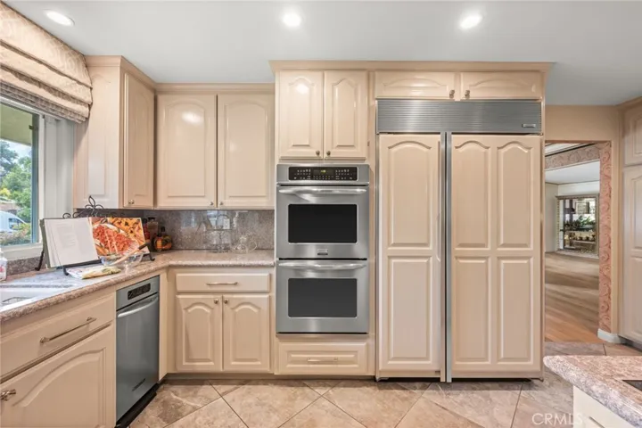 Double ovens, large Sub-Zero refrigerator, stone floors and great recessed lighting in the kitchen.