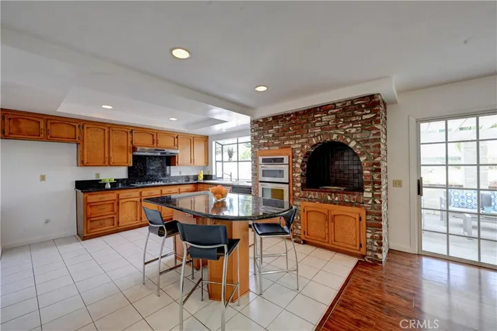 Spacious kitchen with granite counter tops, an indoor grill and a roomy island.