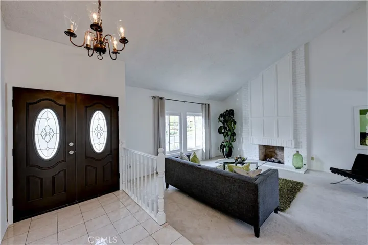 Beautiful rich brown double door and gorgeous tile lead you to the formal living room.