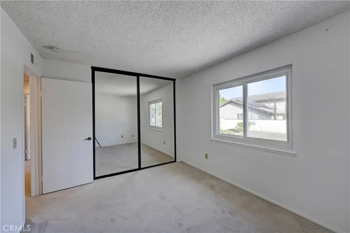 Bedroom #3 with mirrored wardrobe doors.